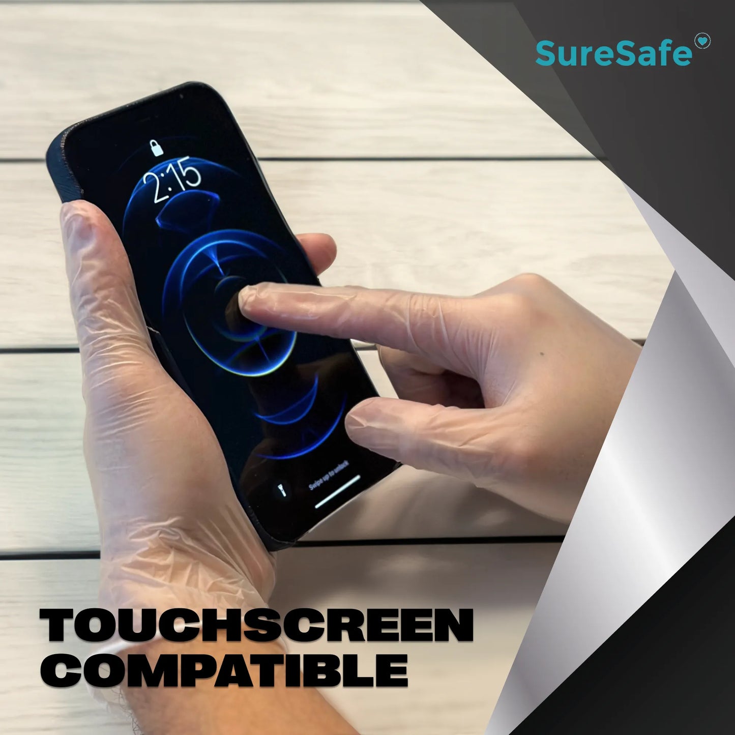 Person wearing clear SureSafe LUCID vinyl gloves using a smartphone to show sensitivity and touchscreen compatibility.